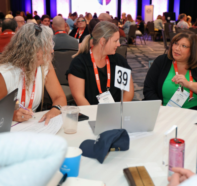 Seminar attendees collaborate at a table during an interactive session at the NSPRA 2025 National Seminar.